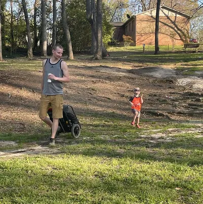 Lane and his son playing disc golf